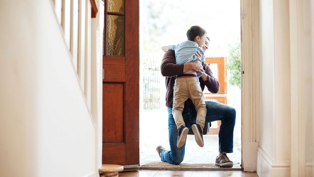 Father greeting son at front door